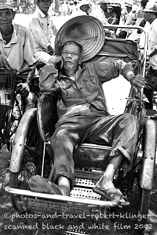 A man sleeping in a rickshaw in Vietnam