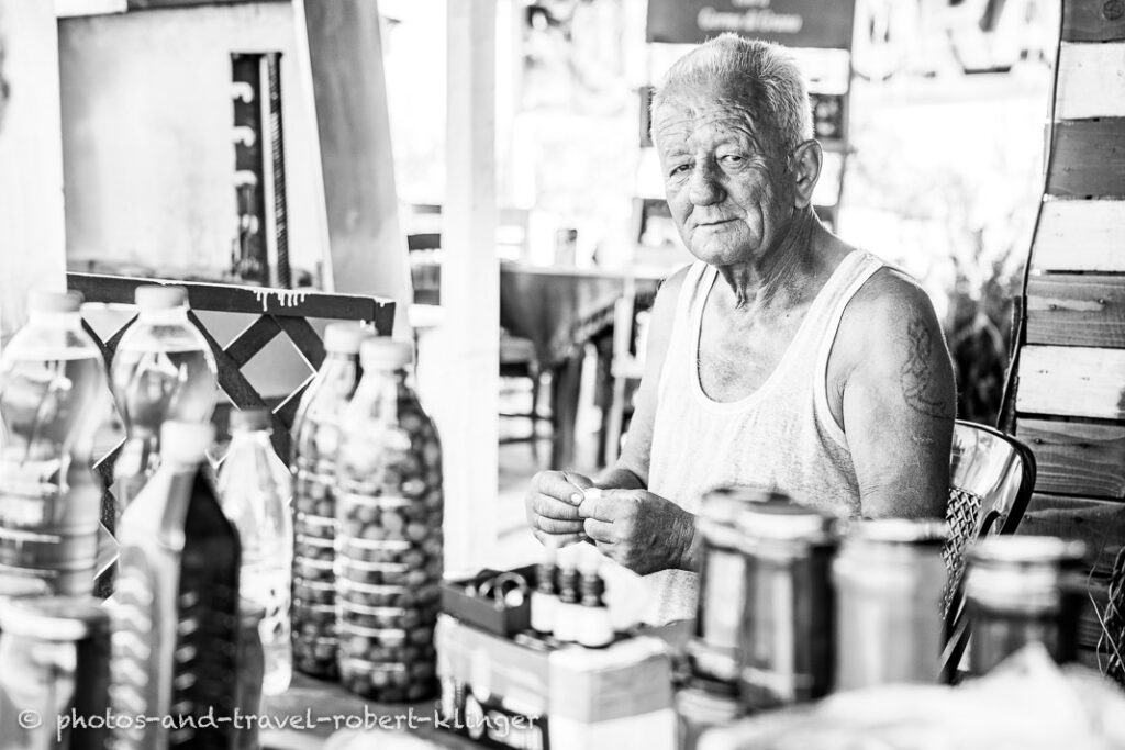 A man selling oil and honey in Albania, black and white photo