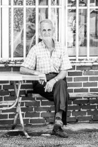 A turkis man sitting on a bench