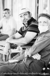 Three men sitting in front of a tearoom, Turkey