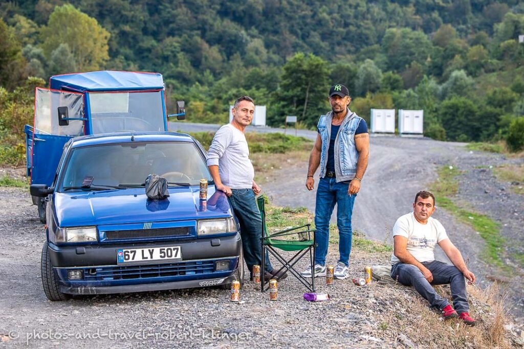 Three young turkish men meeting at the black sea for a barbeque