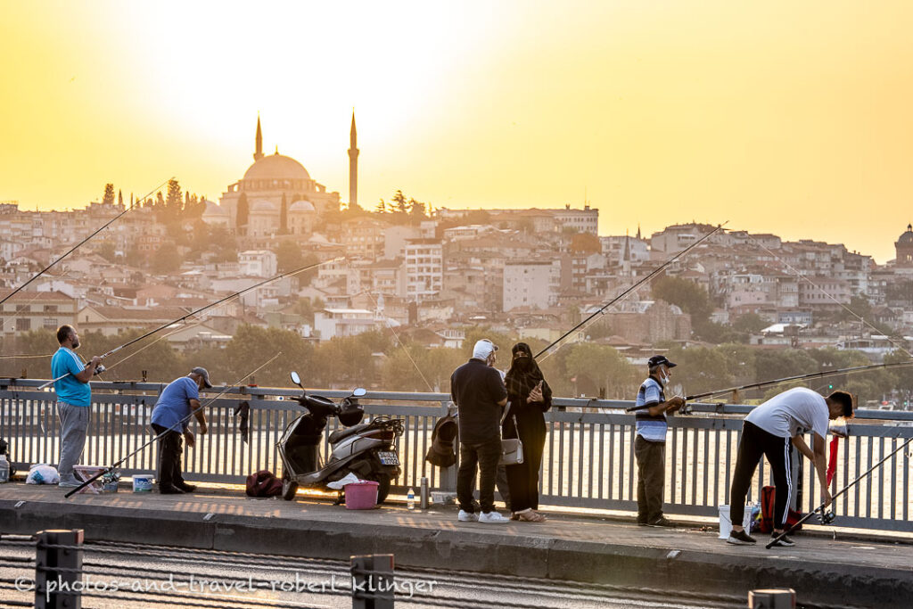 Turkish peple fishing from Atatürk-Bridge in Istanbul during sunset