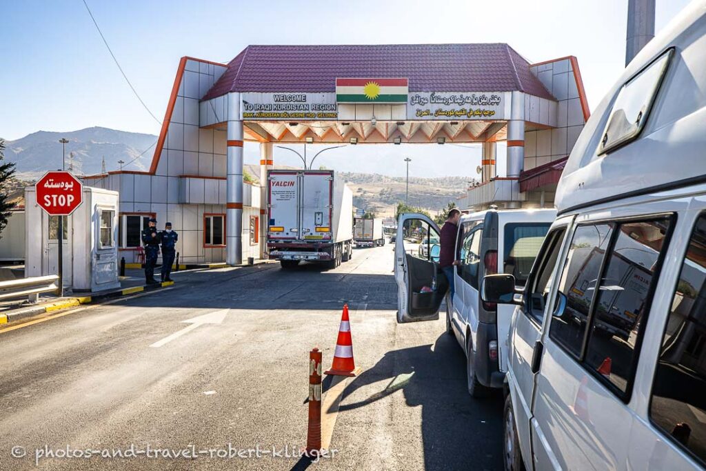 A few cars waiting to cross the border from Turkey to Iraq