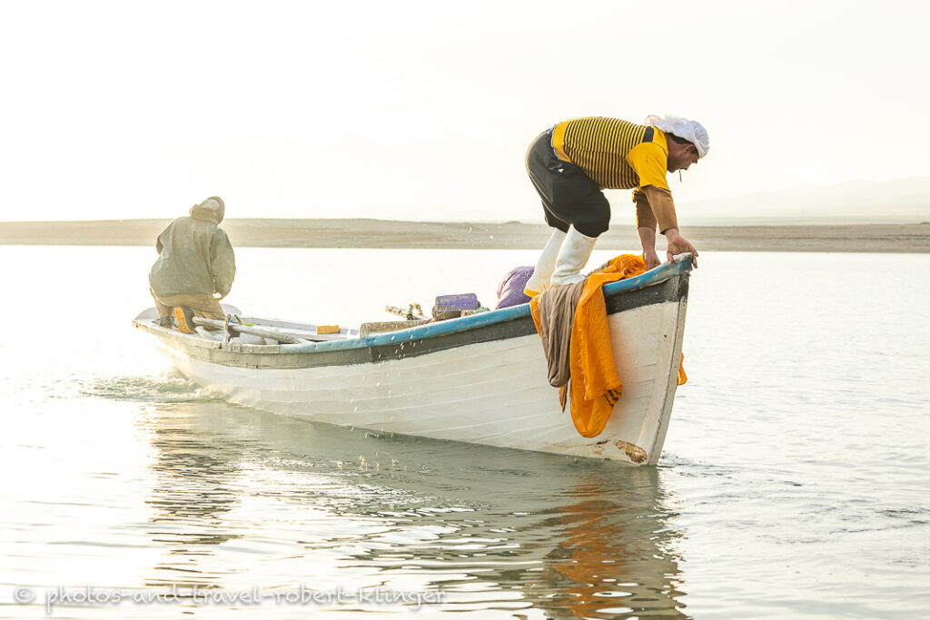 Two fishermen in there boat on Lake Dukan shortly after sunrise